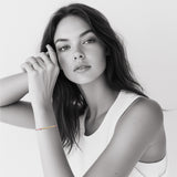 Model wearing 18k gold Morse code bracelet on colorful nylon cord — personalized gift for her birthday or friendship